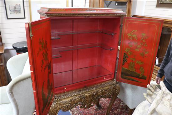 A red lacquer cocktail cabinet on stand, W.105cm